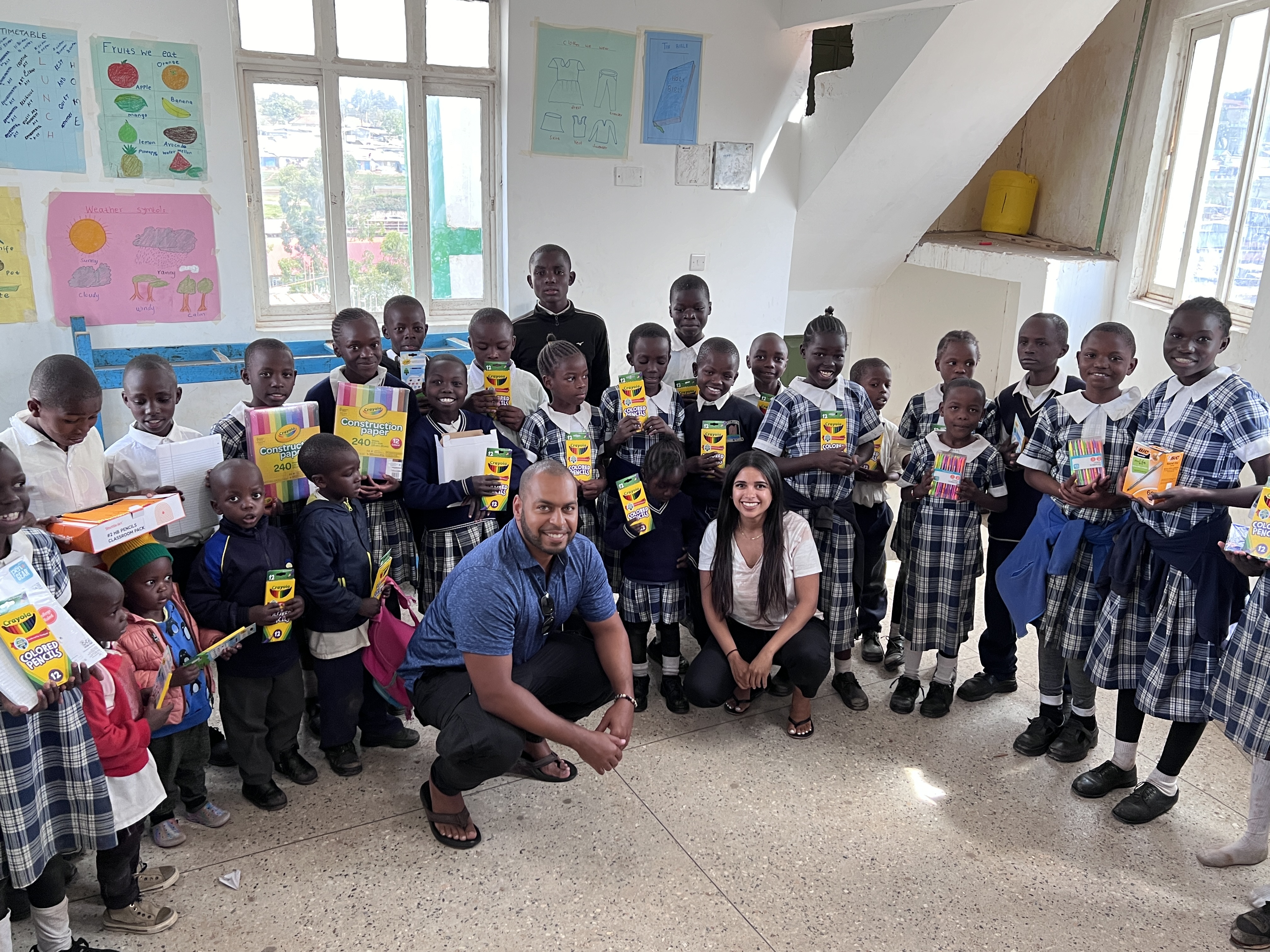 Jason and Katherine delivering school supplies to children in Kenya